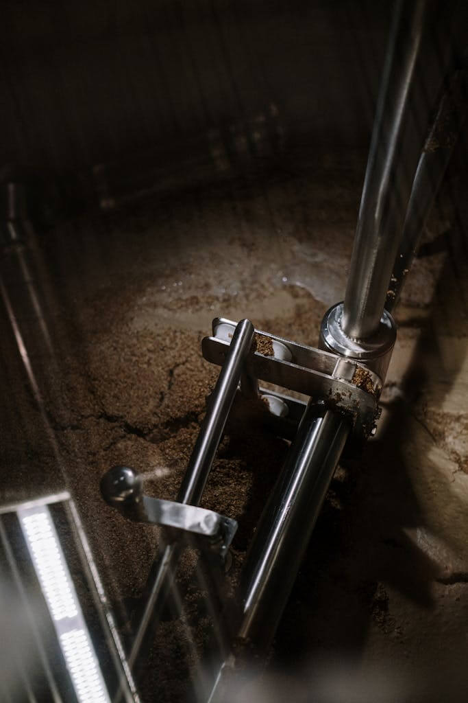 Close-up of industrial brewing equipment in a microbrewery setting.